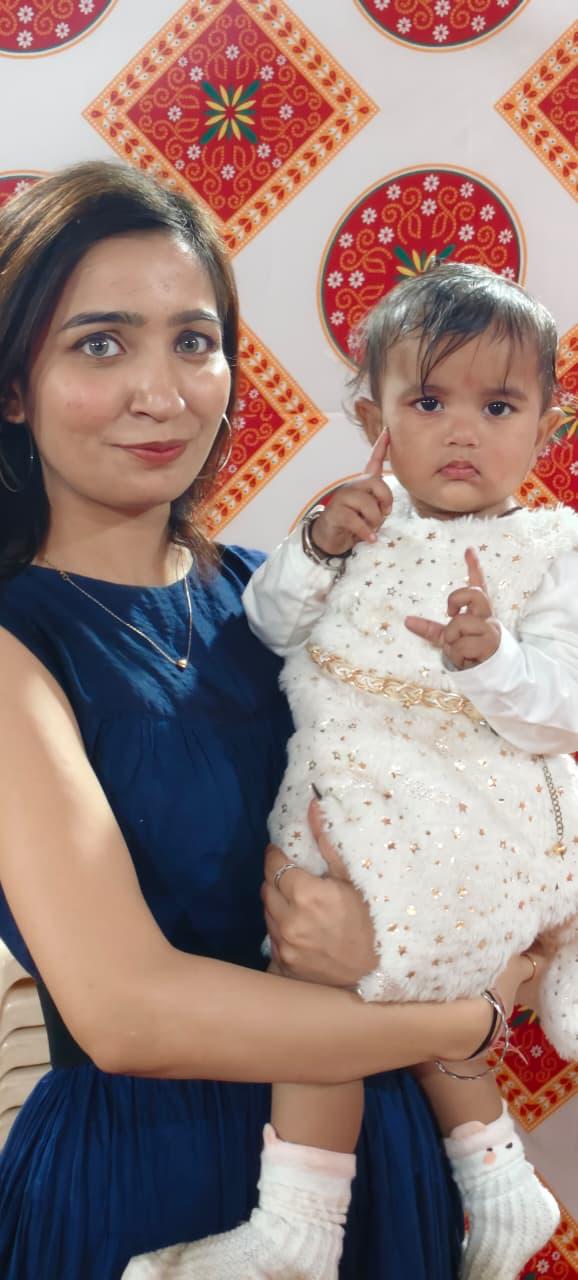 Payal holding baby lovingly